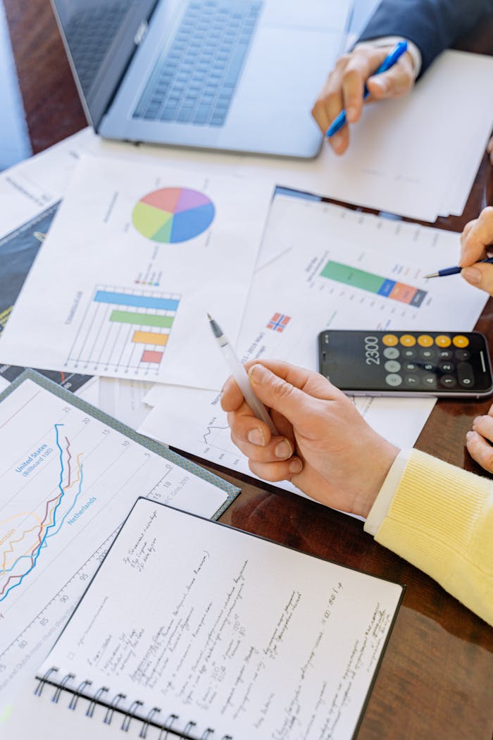 menu-07 A close-up of businesspeople analyzing financial data and charts during a meeting.