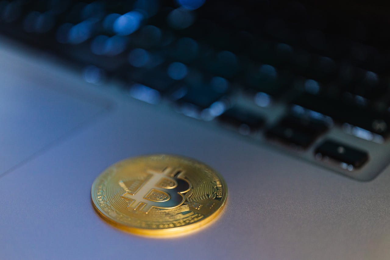 about-03 Close-up of a Bitcoin coin on a laptop, symbolizing digital currency and technology.