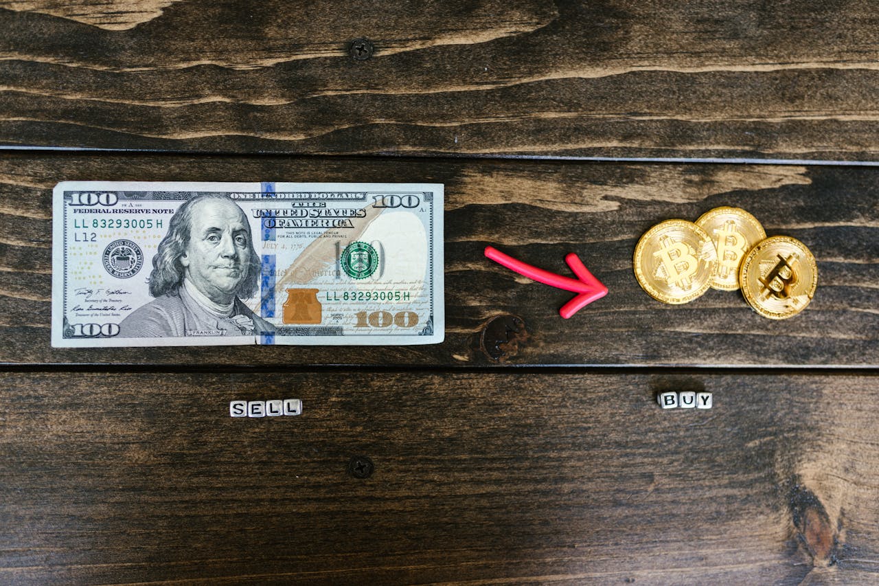 menu-13 Bitcoin coins and a dollar bill symbolize digital and traditional currency trade.